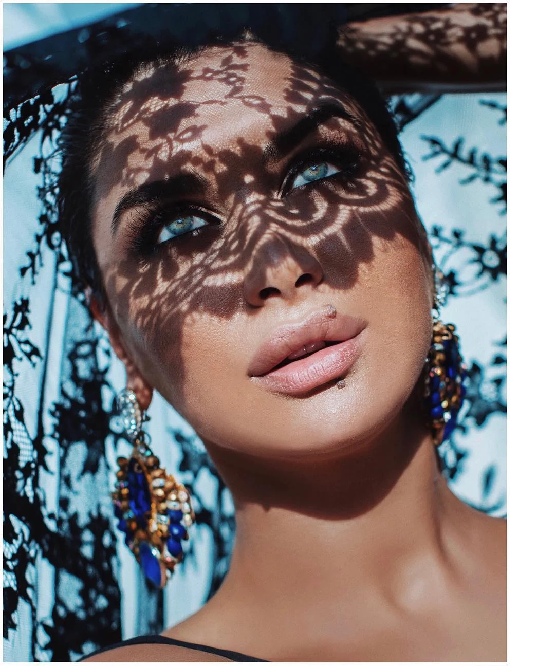 Fashion makeup seen through patterned lace