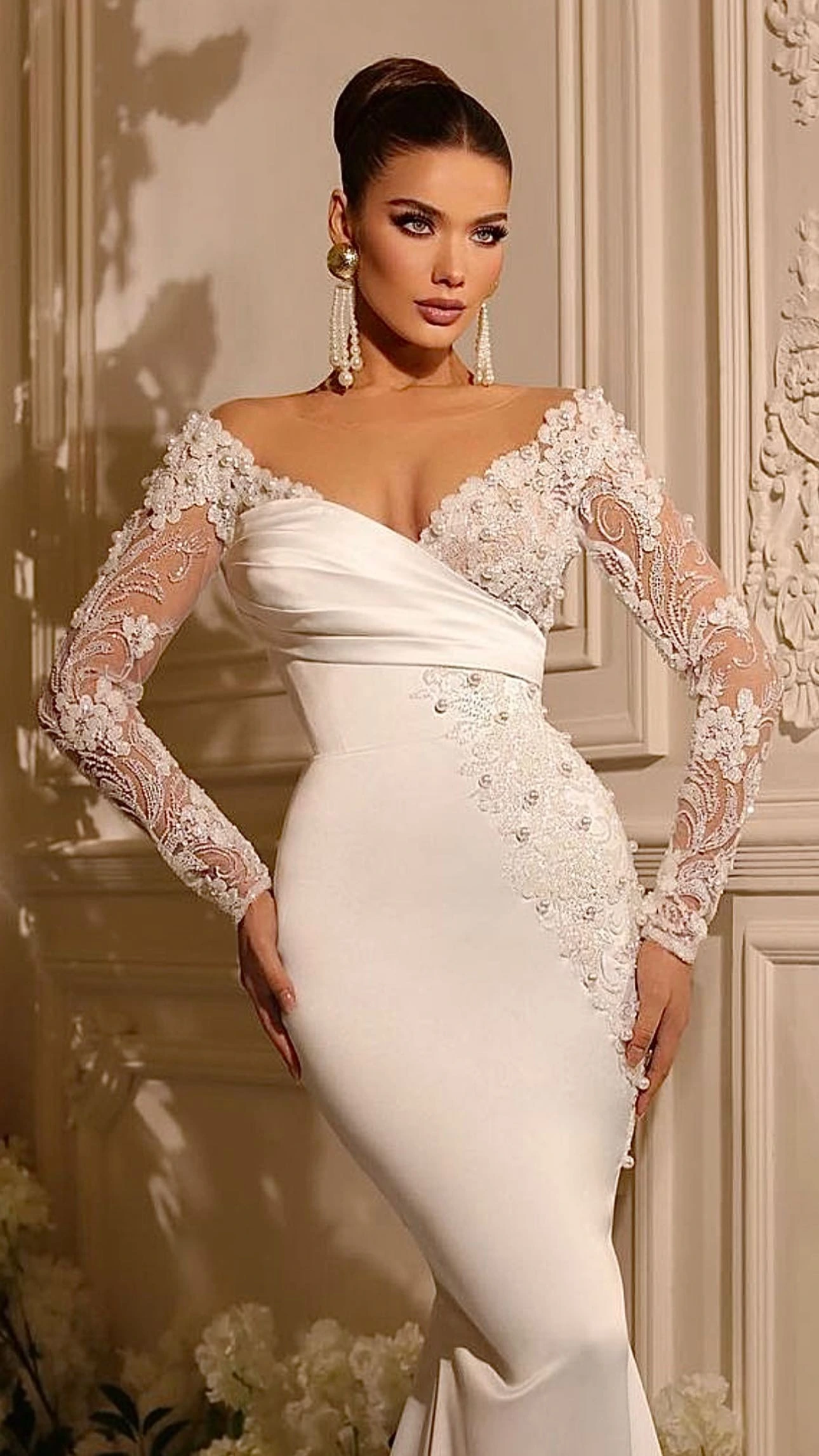 Bridal makeup with defined eyes, a high updo and an ivory lace wedding gown